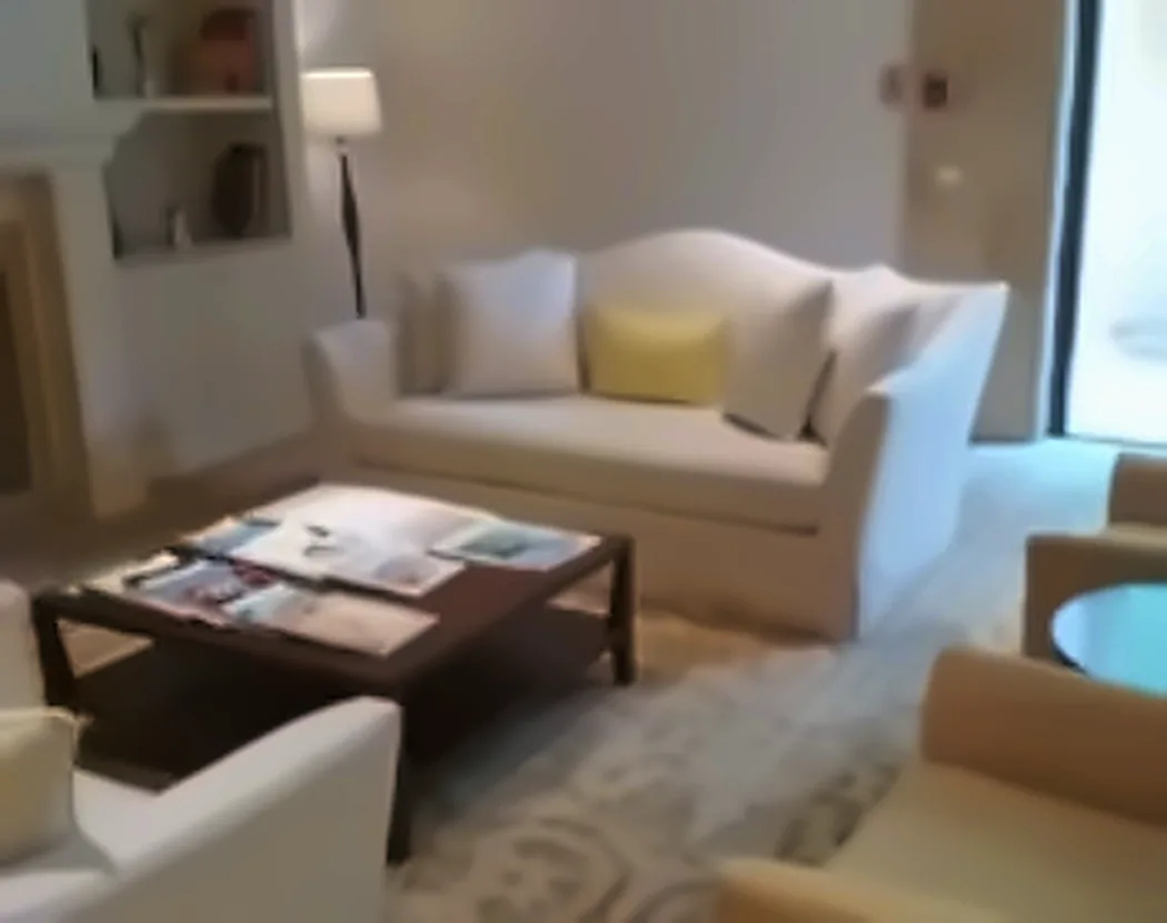 A bright sitting area with a cream sofa and cushions